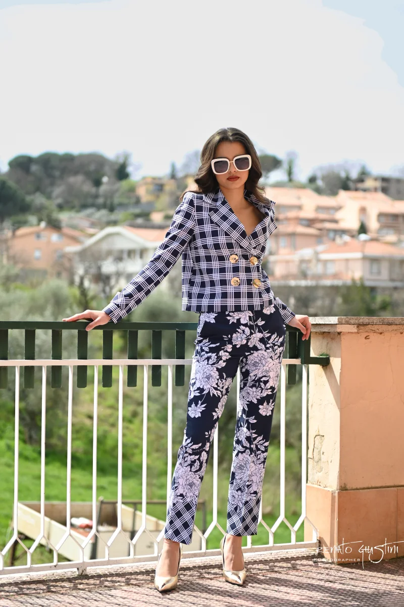 Modella con completo sartoriale blu a quadri e pantaloni floreali